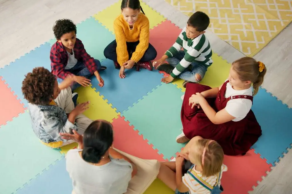 Young children sitting on the floor at daycare.