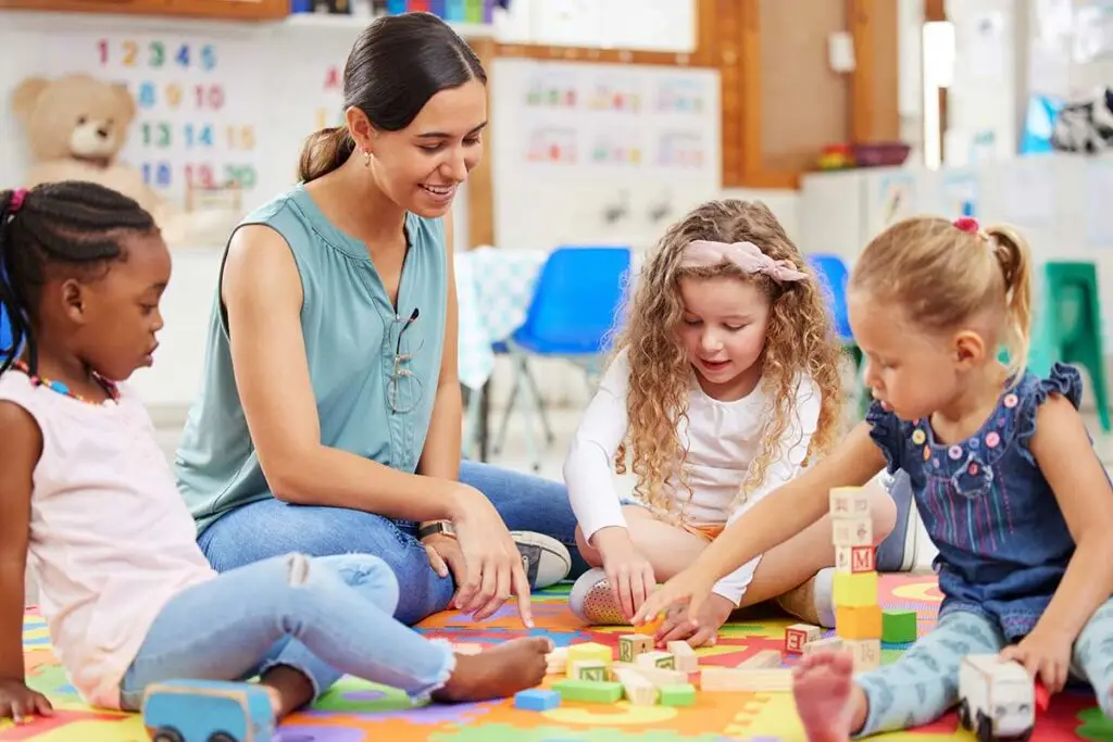 Teacher working with children on an educational activity.
